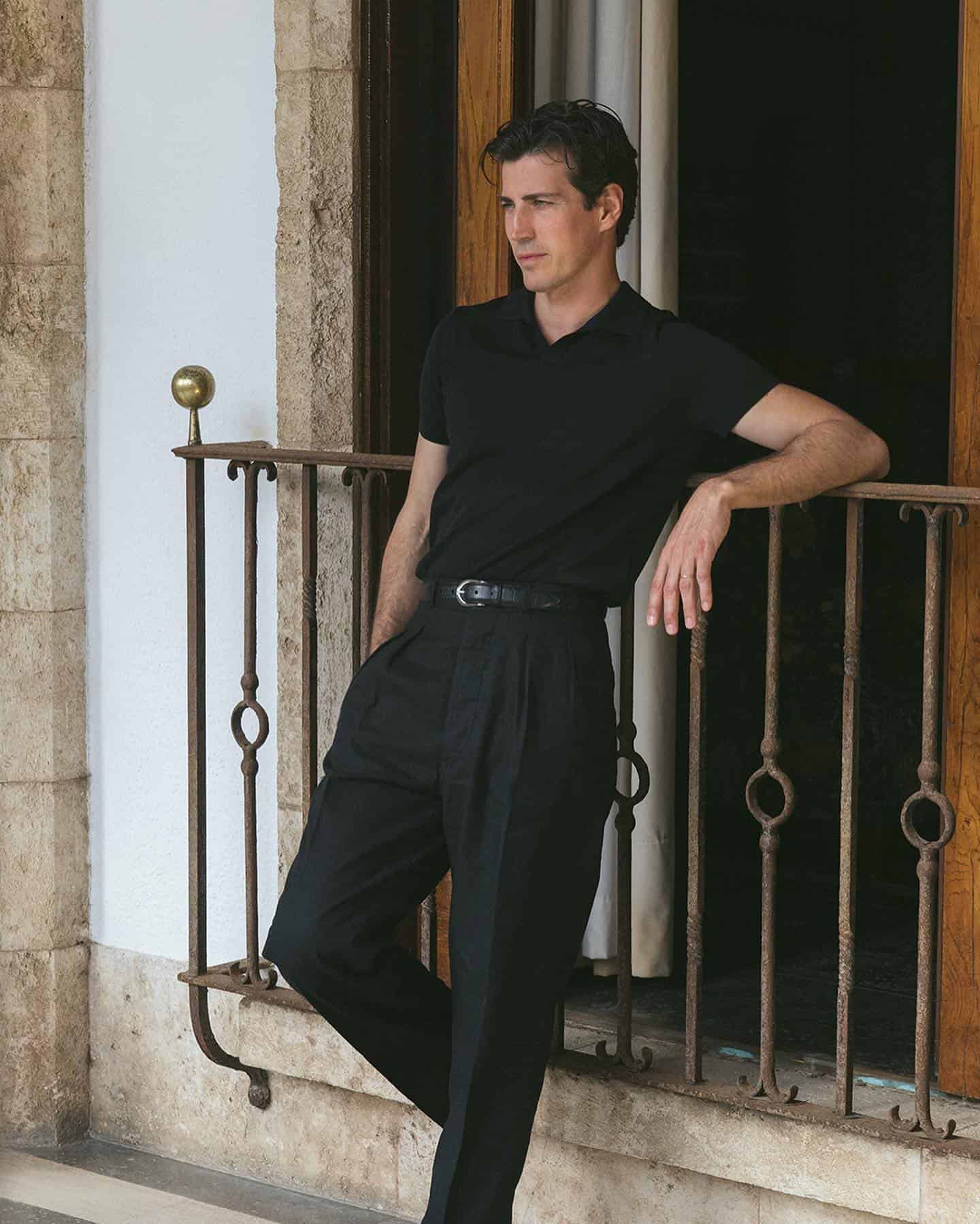 man leaning on a metal railing