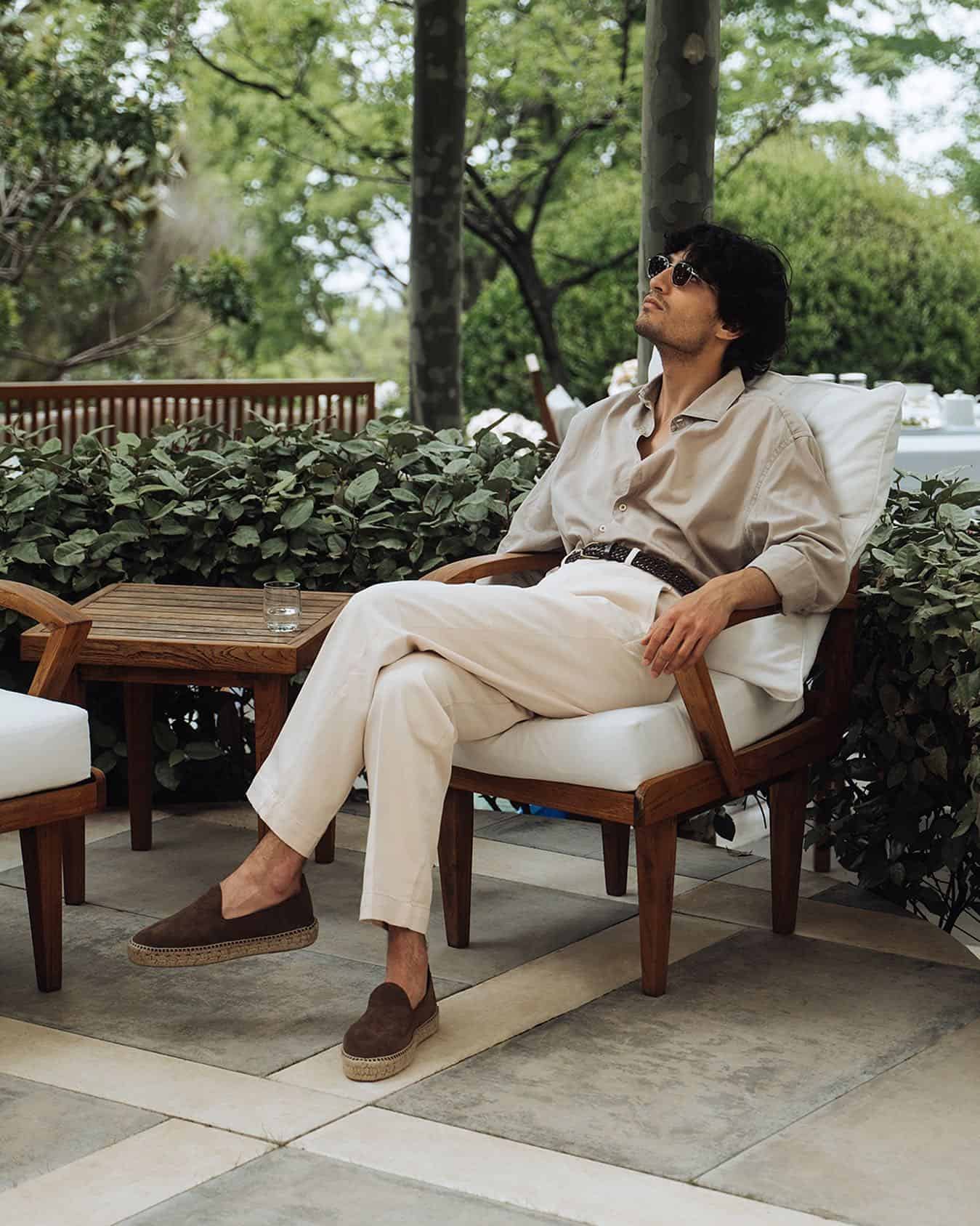 man sitting on a chair with legs crossed