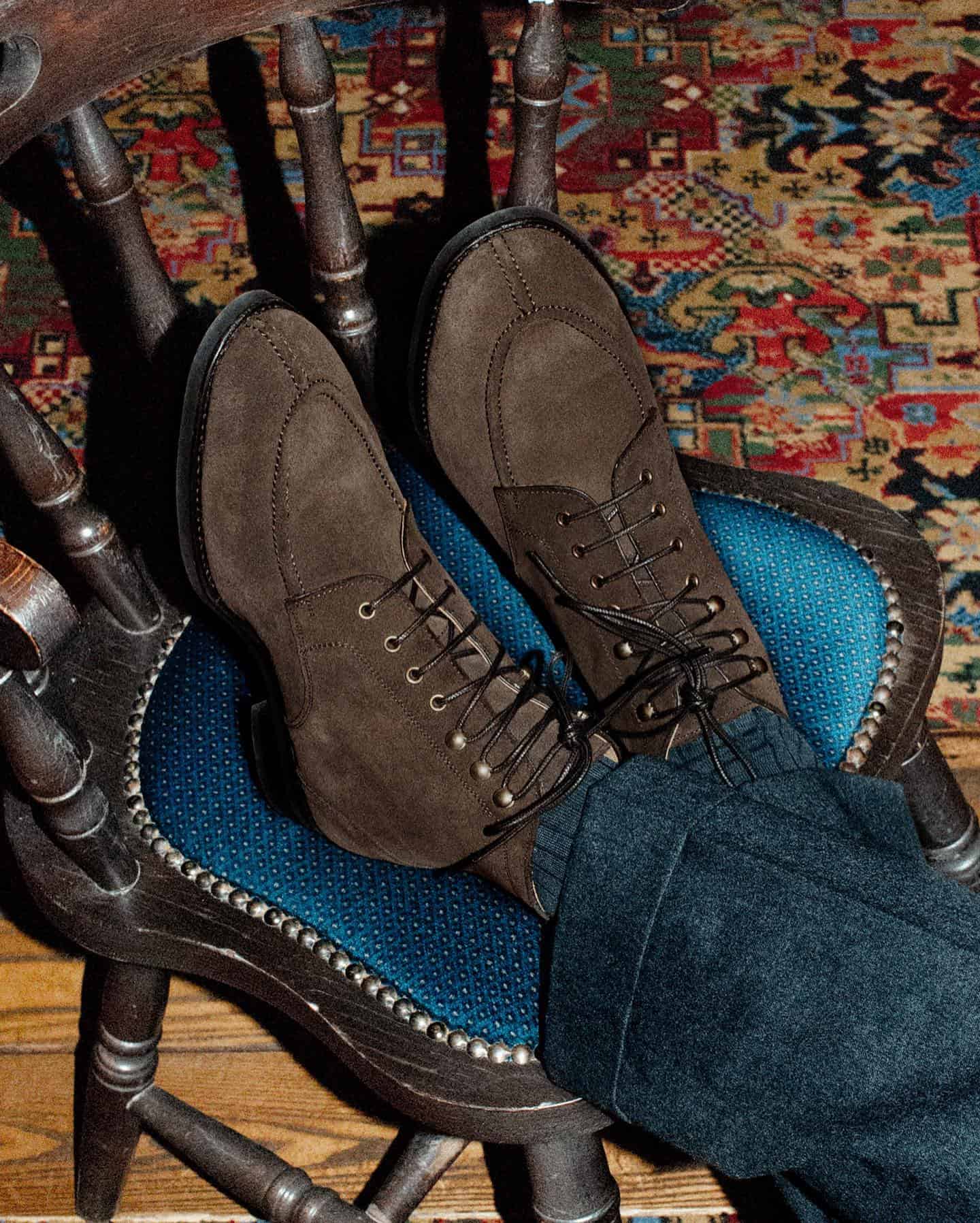 man resting his feet on a chair