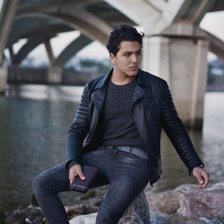 man sitting on a rock by the river