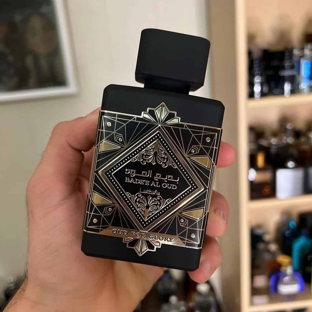 holding a bottle of Oud for Glory by Lattafa