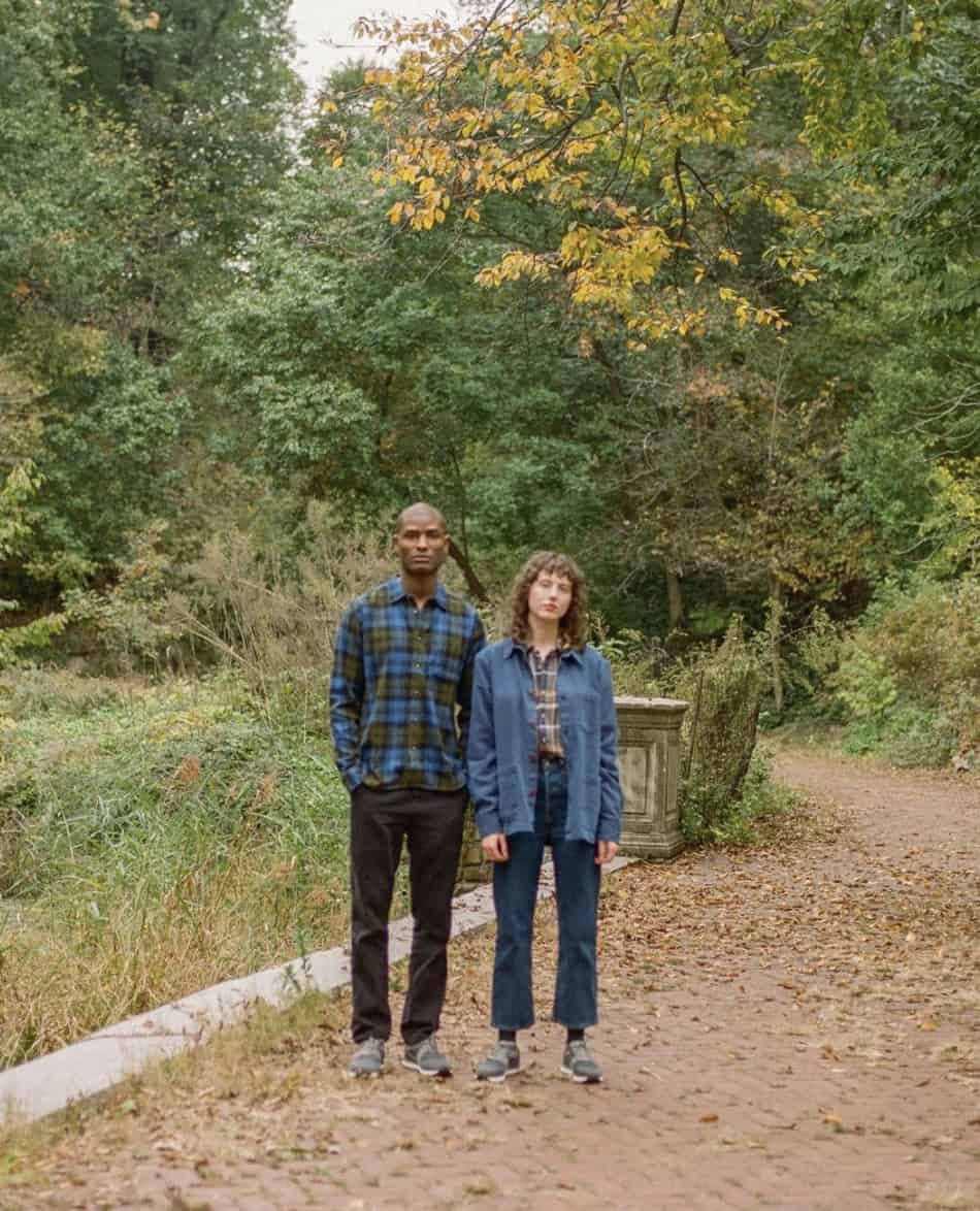 man and women standing on a trail, during fall