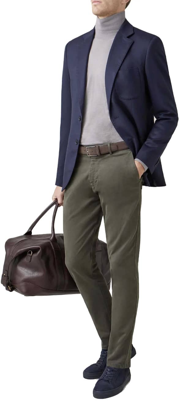Model wearing chinos and blazer with a weekend bag 