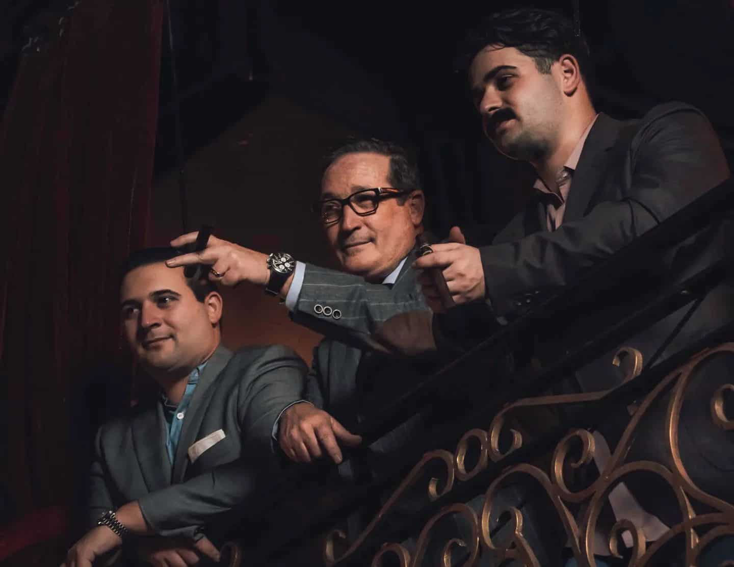 three man on the balcony having conversations