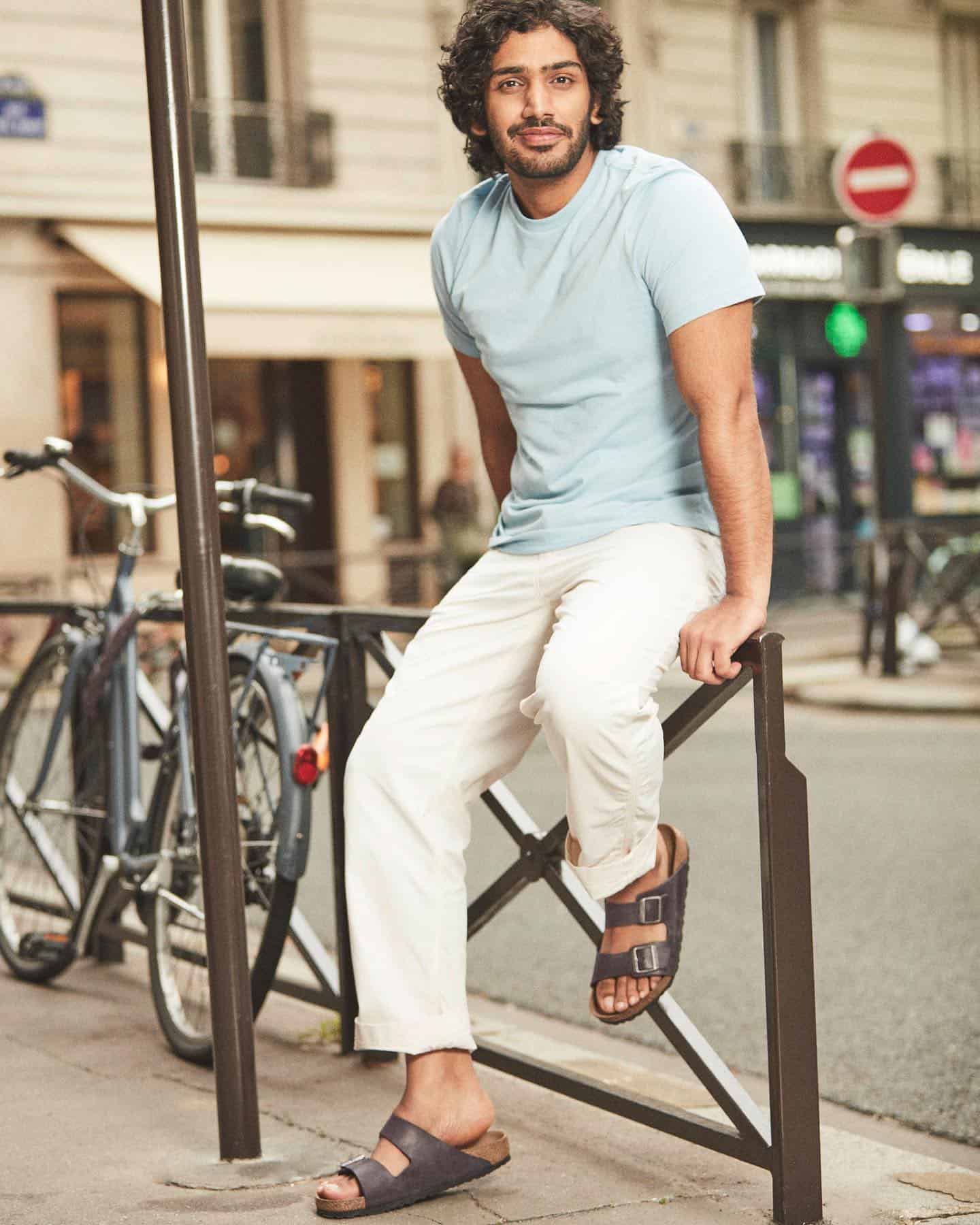 man sitting on railings