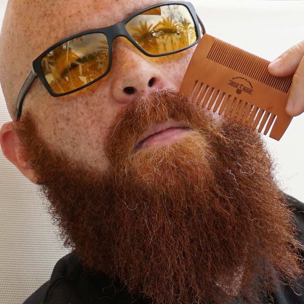 man combing his long beard