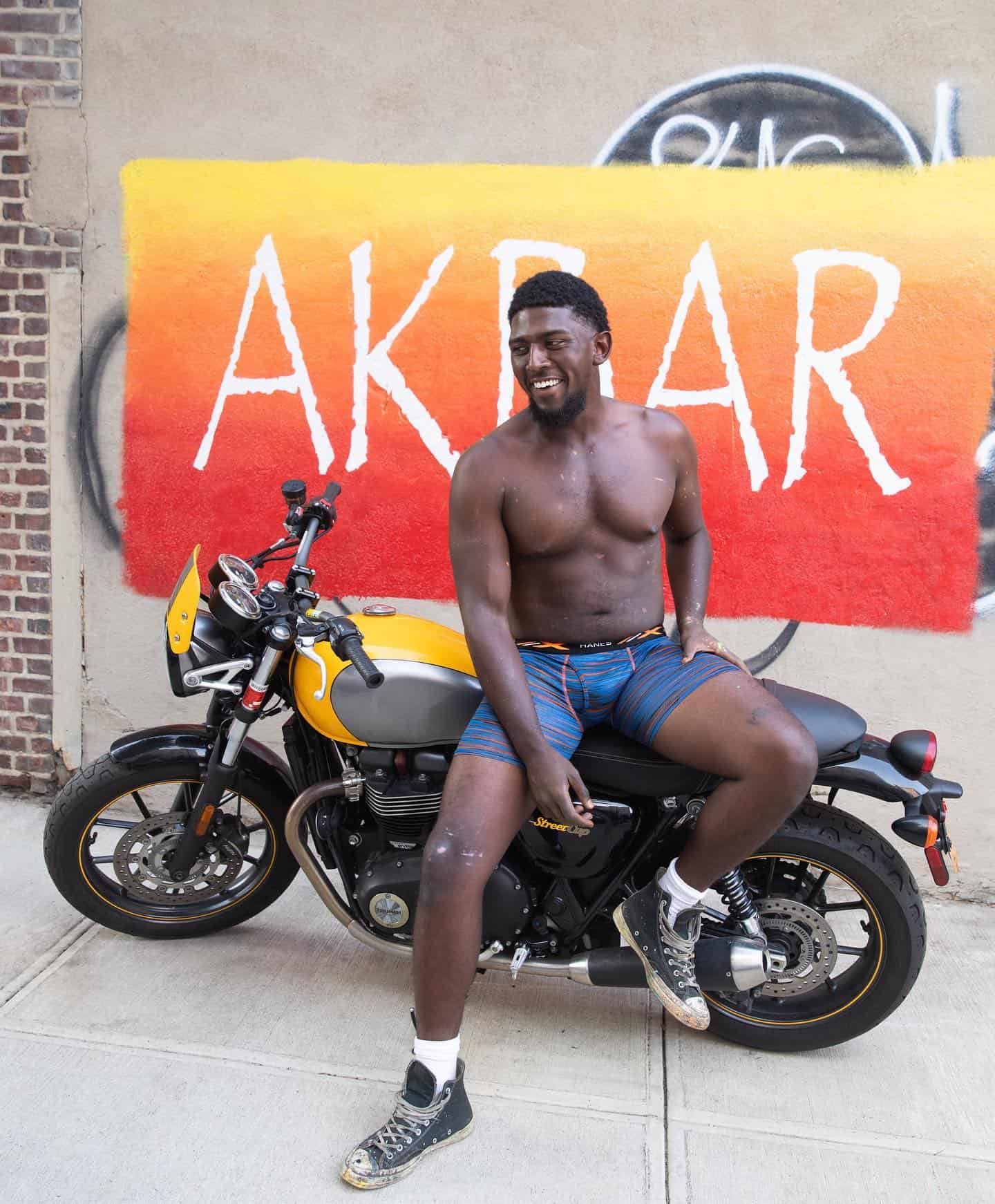 man in boxer brief sitting on a motorcycle