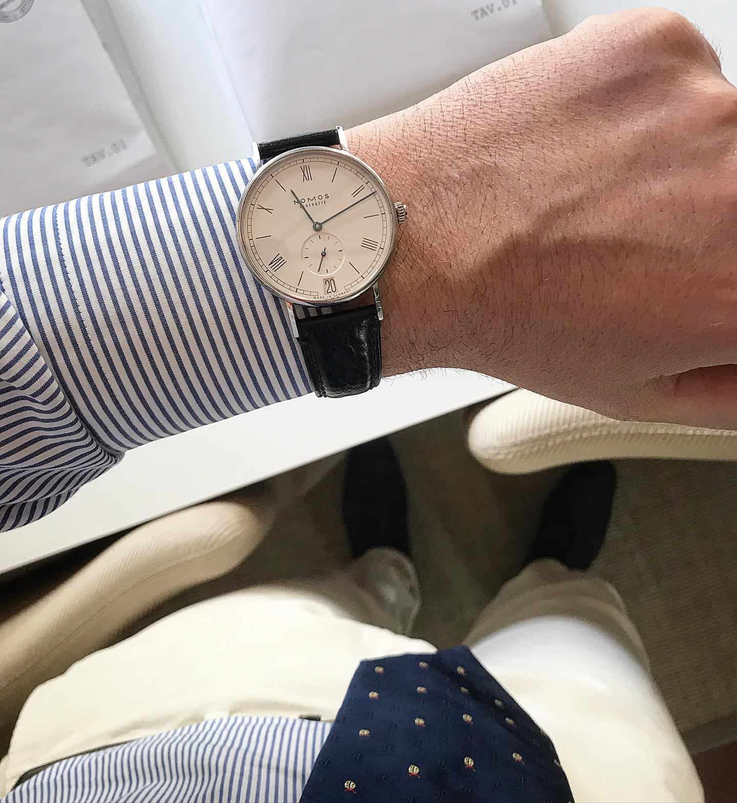 man wearing a NOMOS Glashütte watch