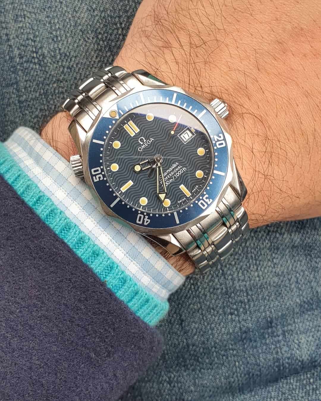 wearing an omega seamaster dive watch
