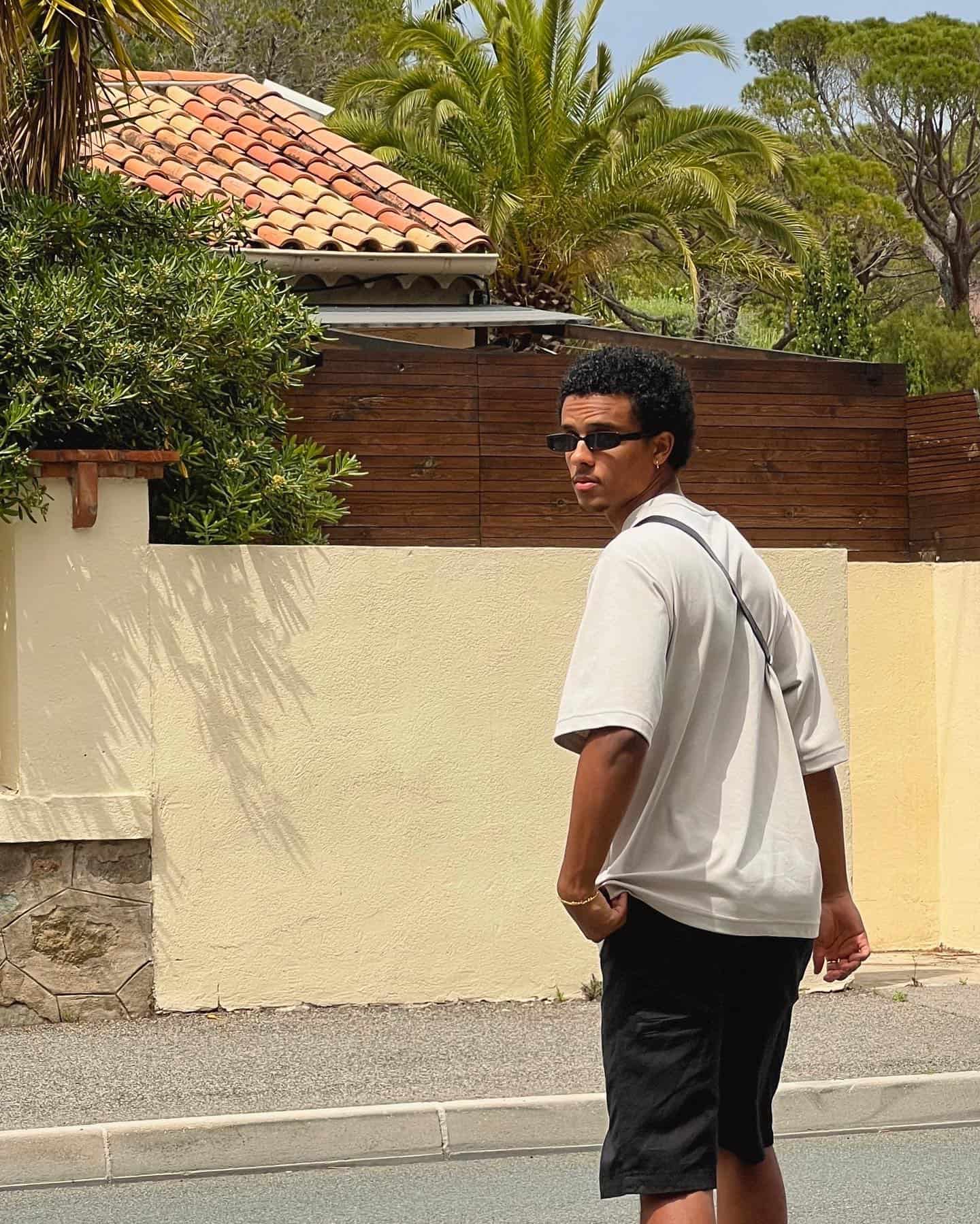 man in sunglasses crossing the street