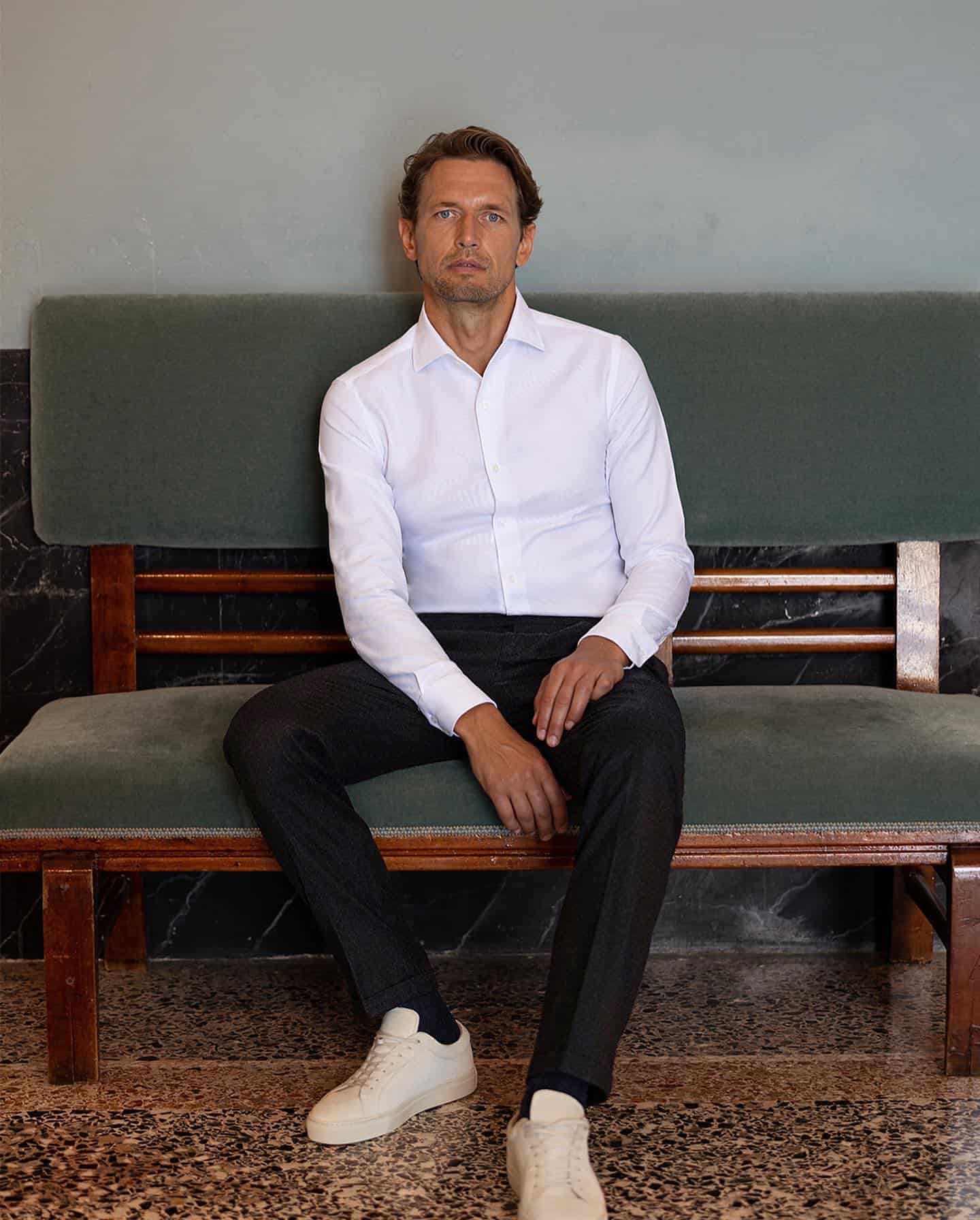man in a white shirt and sneakers