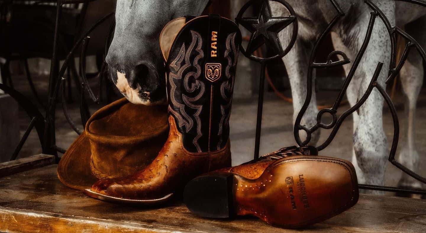 a pair of cowboy boots and a hat on a bench