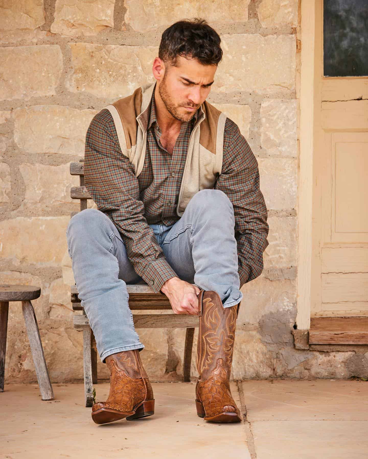 putting on a pair of cowboy boots
