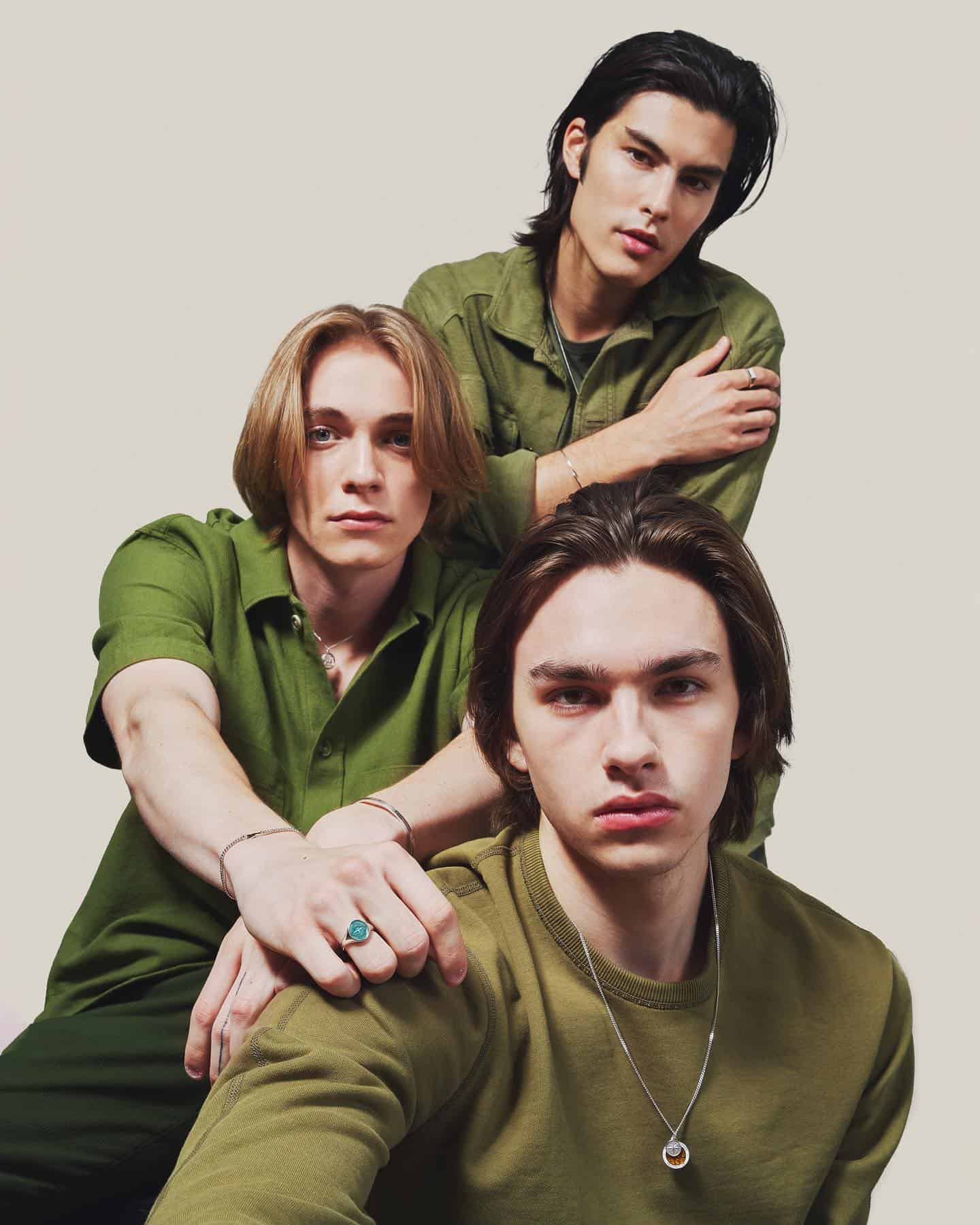three young man wearing green outfits