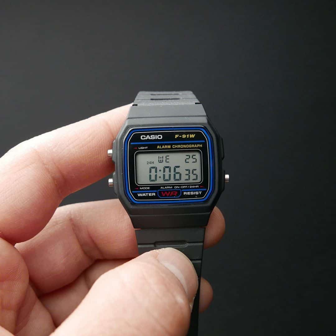 man holding a Casio F-91w