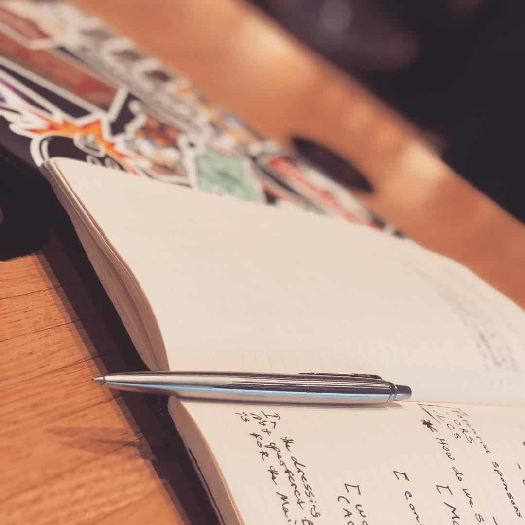 pen resting in the middle of an open notebook