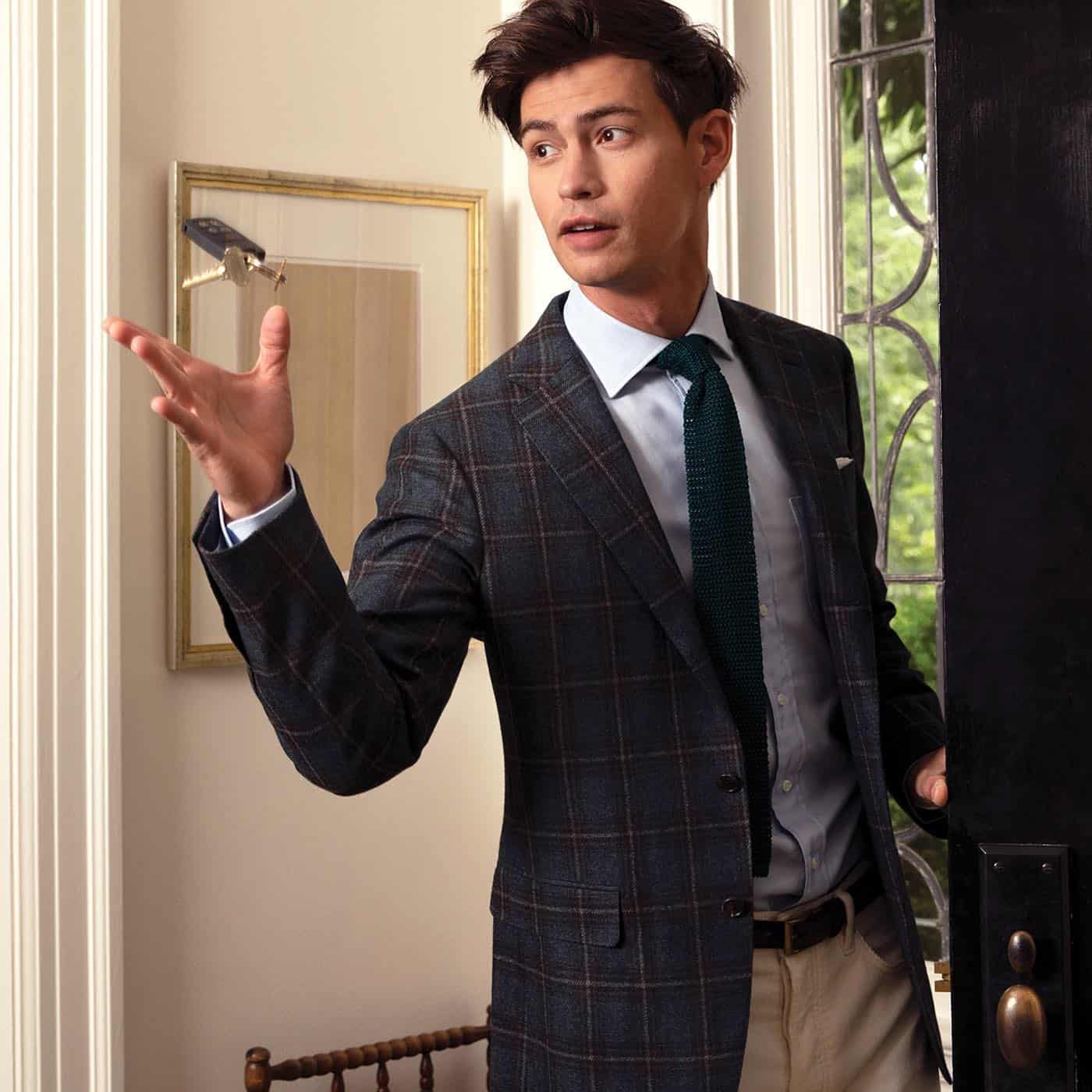 man in a jacket catching a key