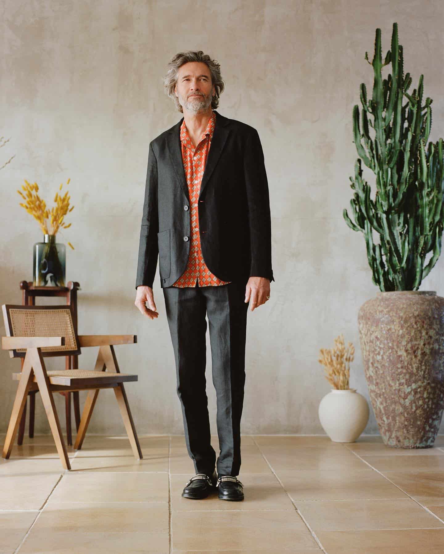 man in a black linen suit