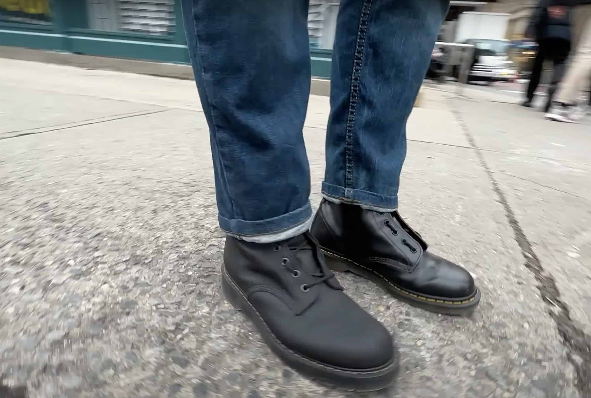 Solvair and Dr Marten boot on each foot 