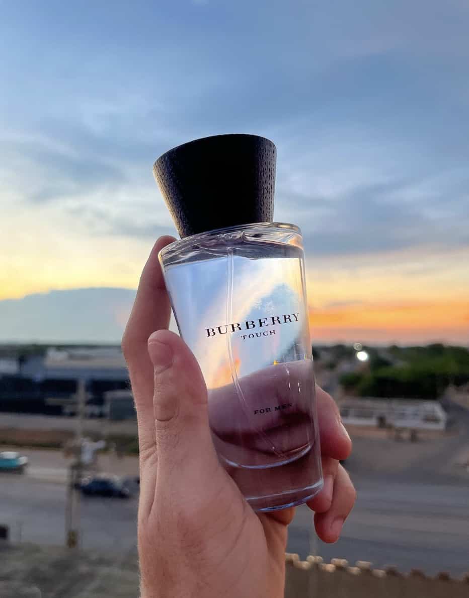 Burberry Touch being held up against the sunset
