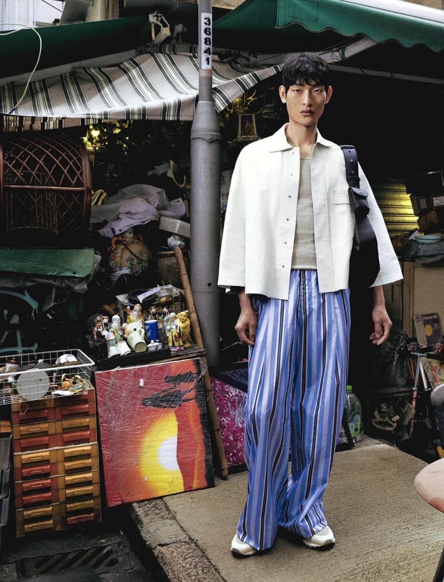 model standing in front of a store wearing pedro shoes and accessories