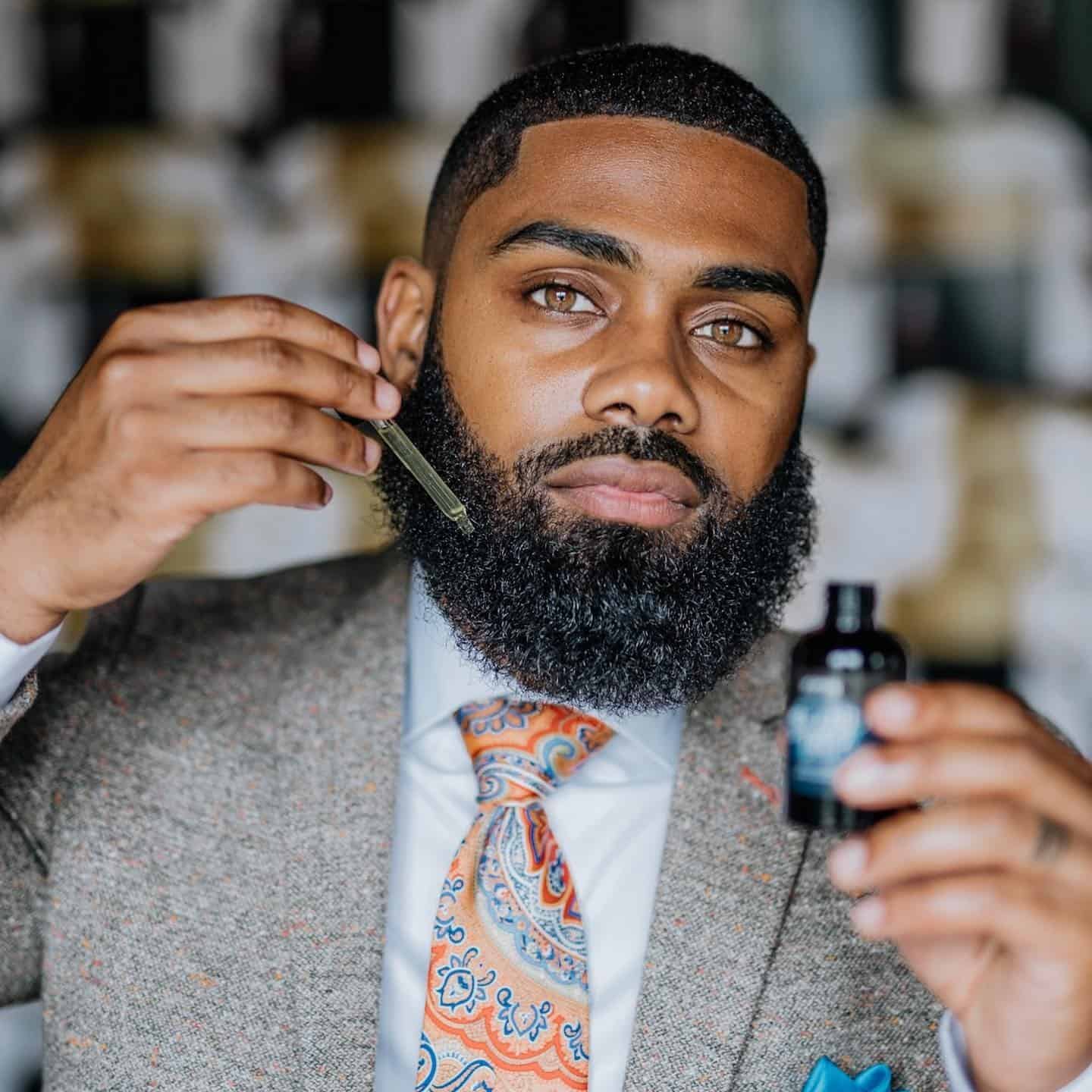 man applying a beard growth oil
