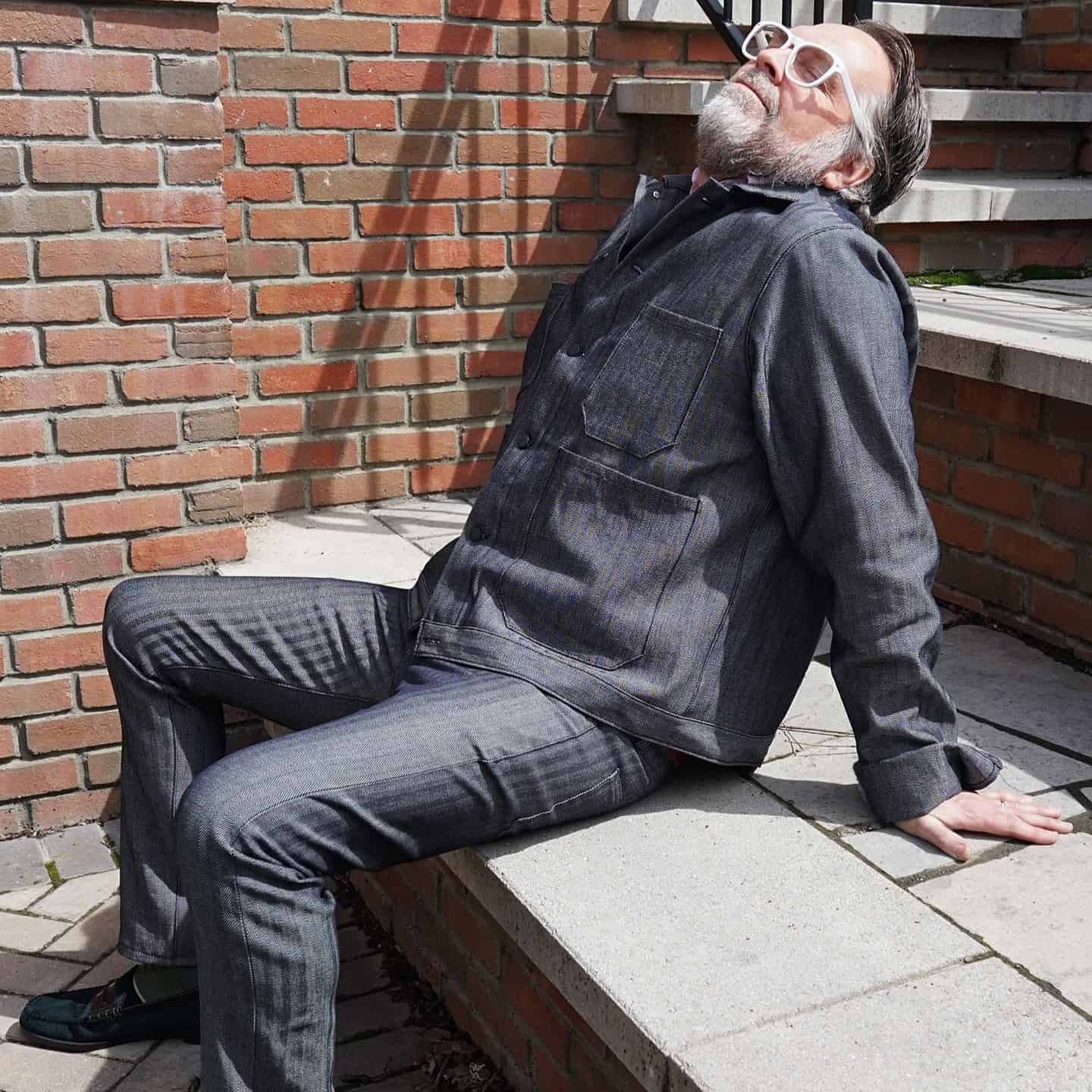 man in a denim outfit enjoying the sun