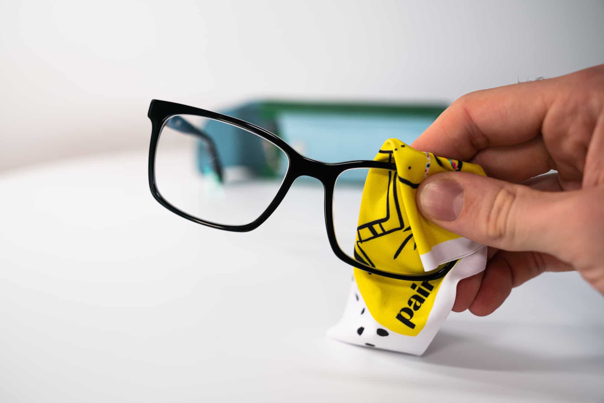 hand cleaning a eyewear lens 