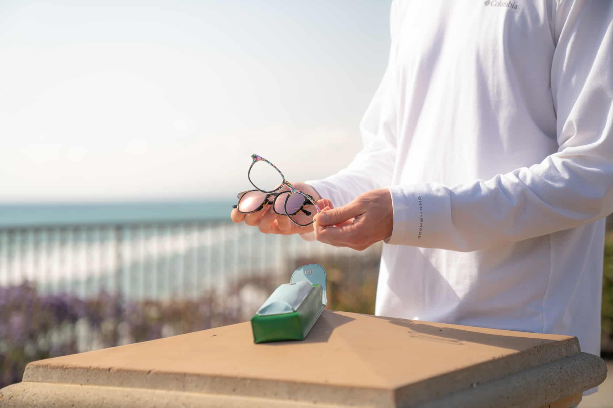 man holding eyeglasses with a snap on top frame 