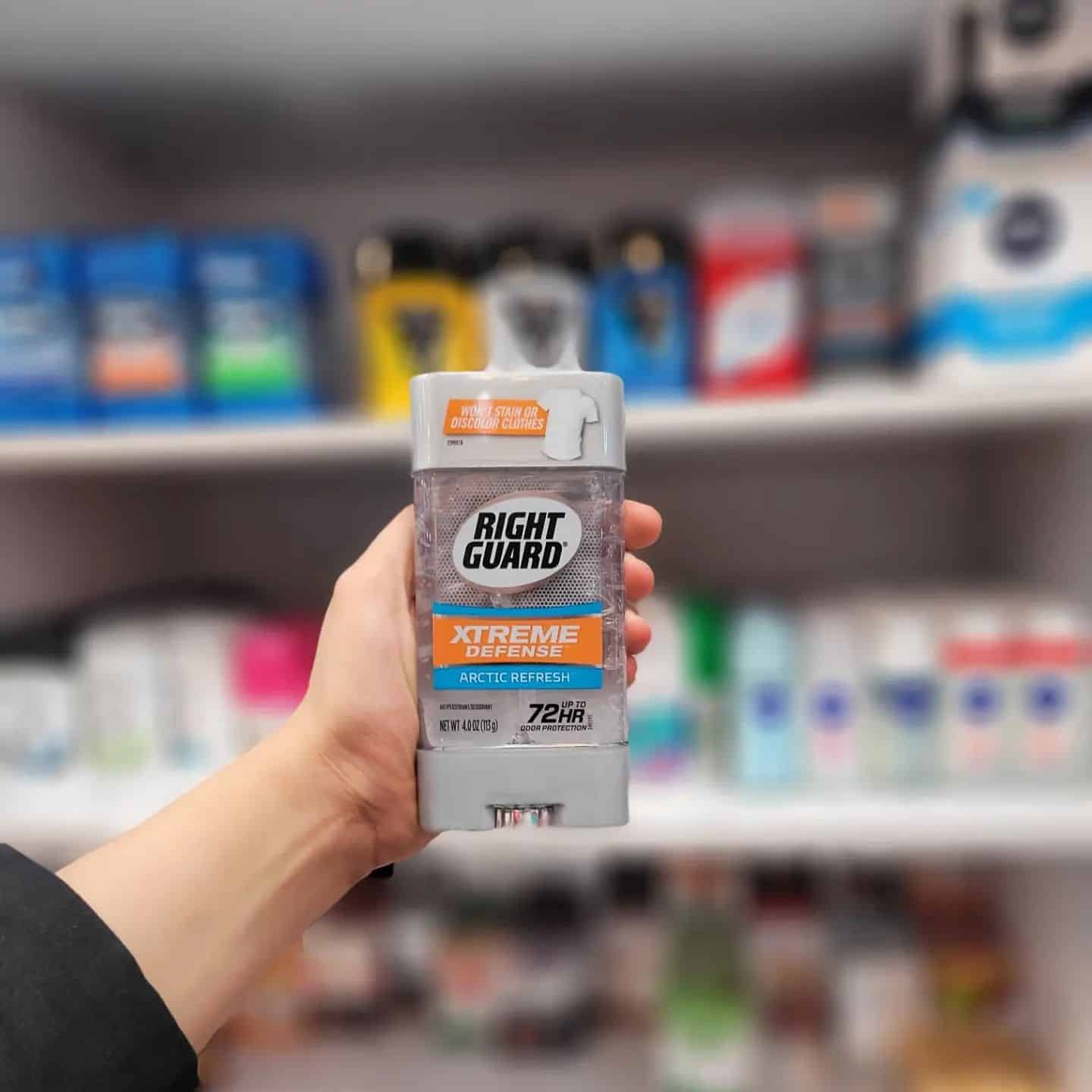 holding a bottle of clear gel deodorant