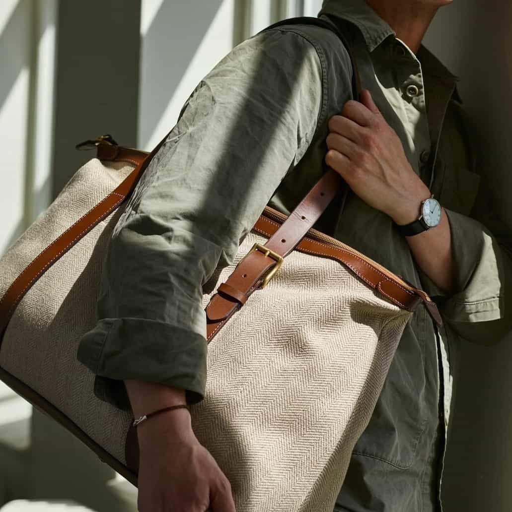 man carrying a holdall bag on his shoulder