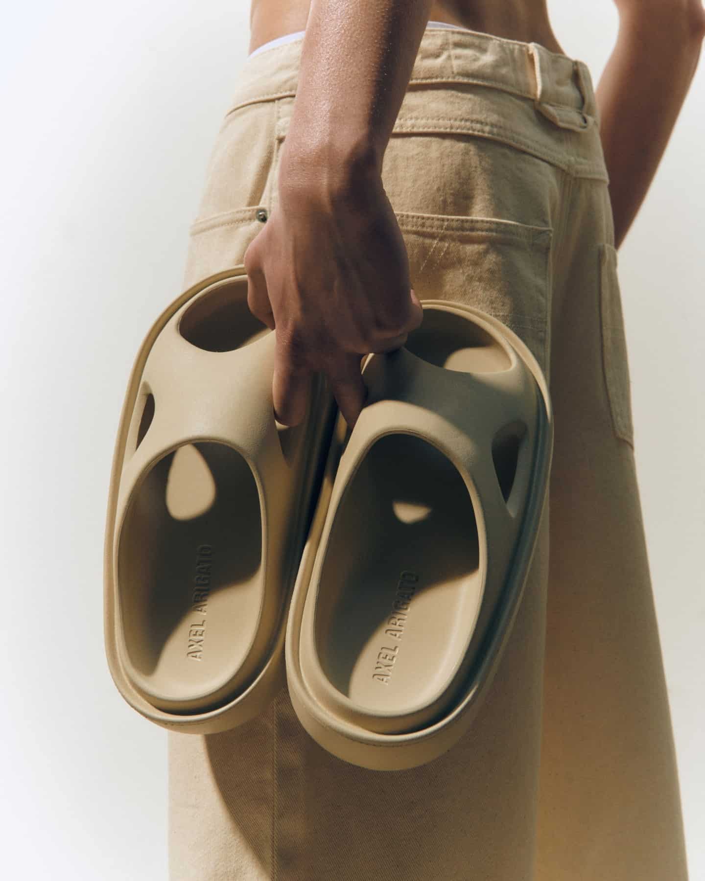carrying a pair of magma slides from axel arigato