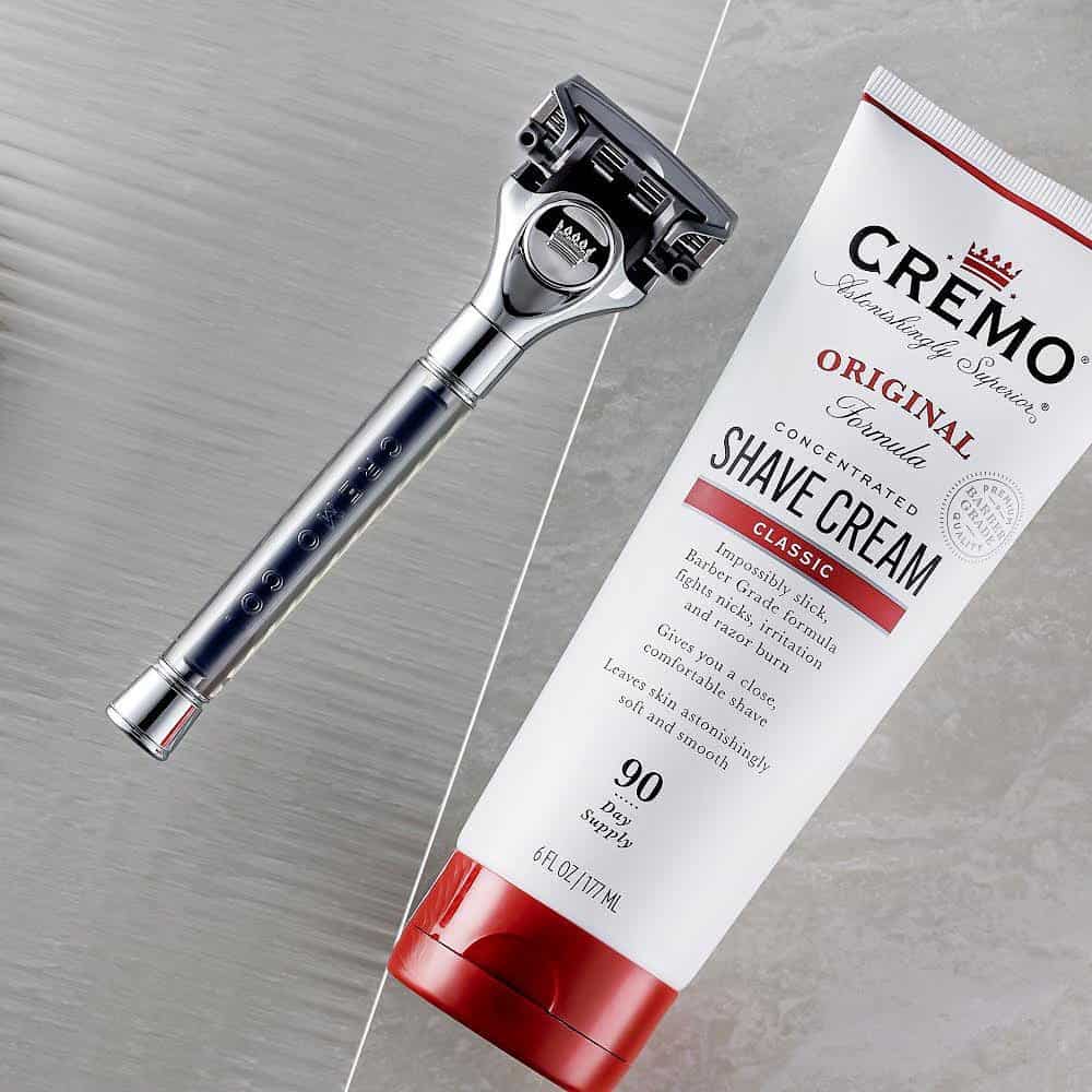 cremo shaving cream and a razor
