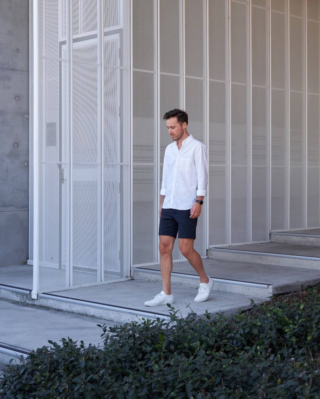 man in shorts walking down the stairs