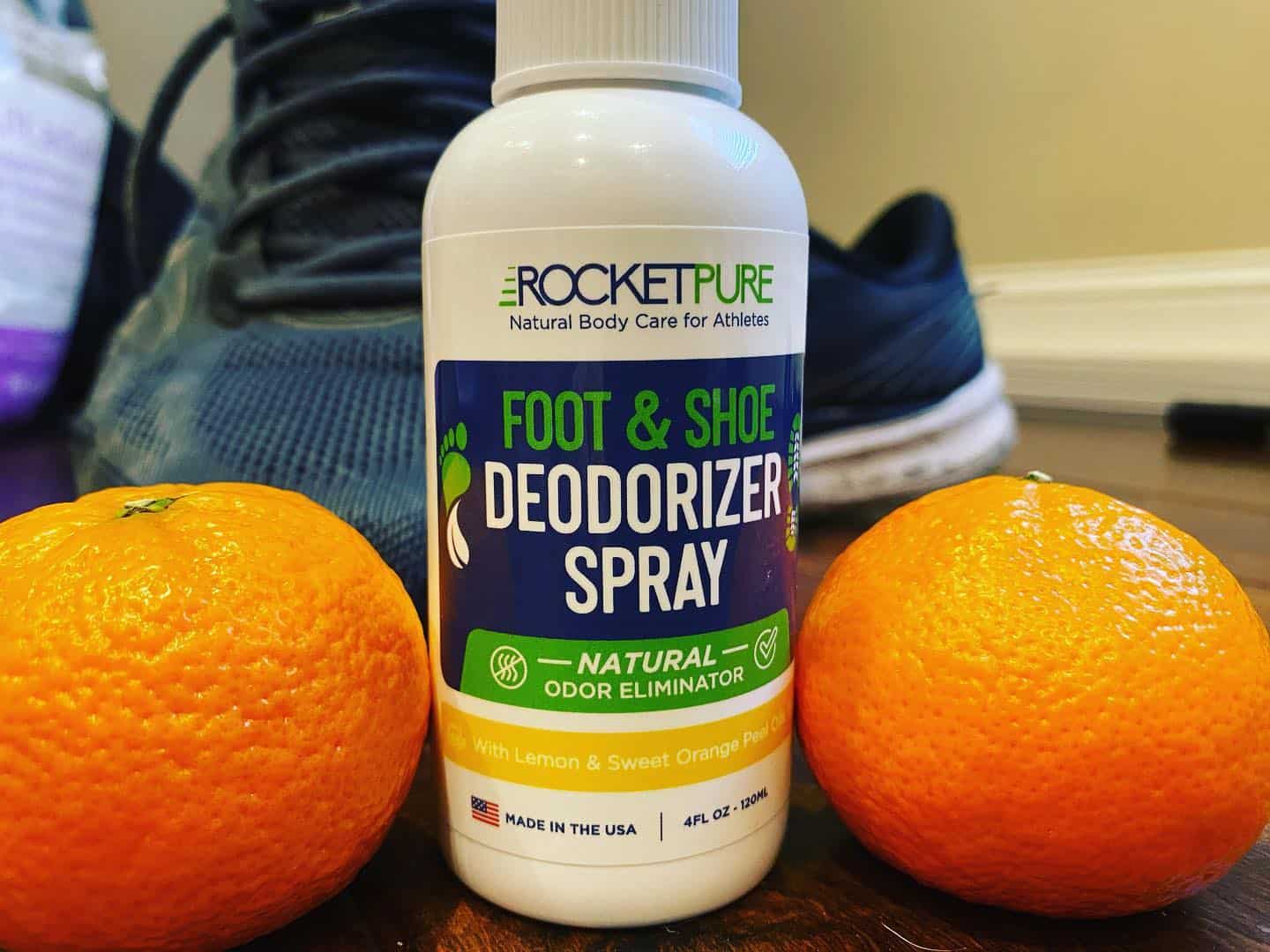 foot and shoe deodorizer spray in-between two oranges