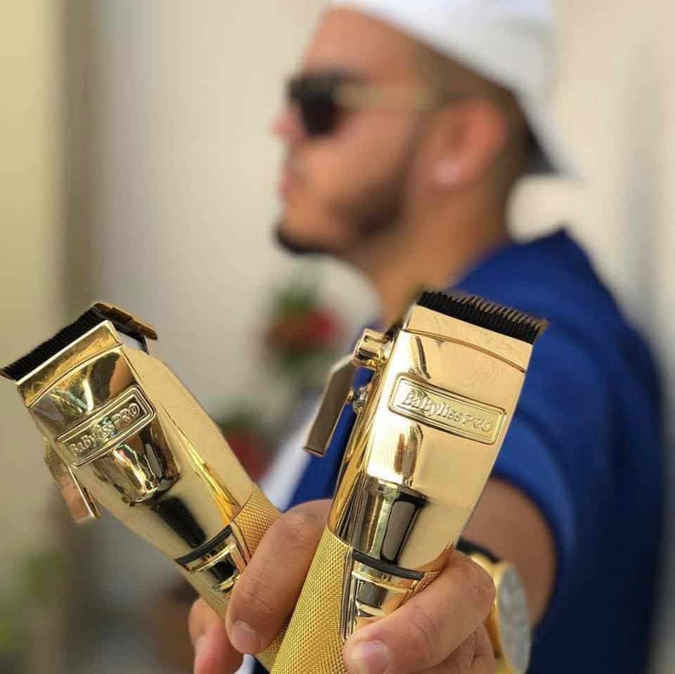 A man holding the gold BabylissPRO Barberology GOLDFX