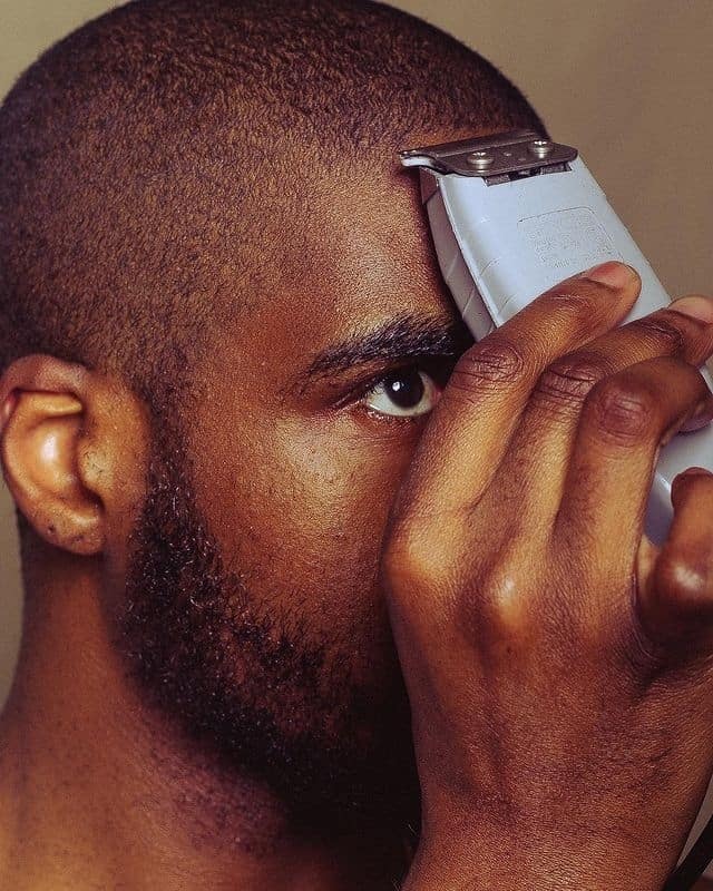 man trimming his hair