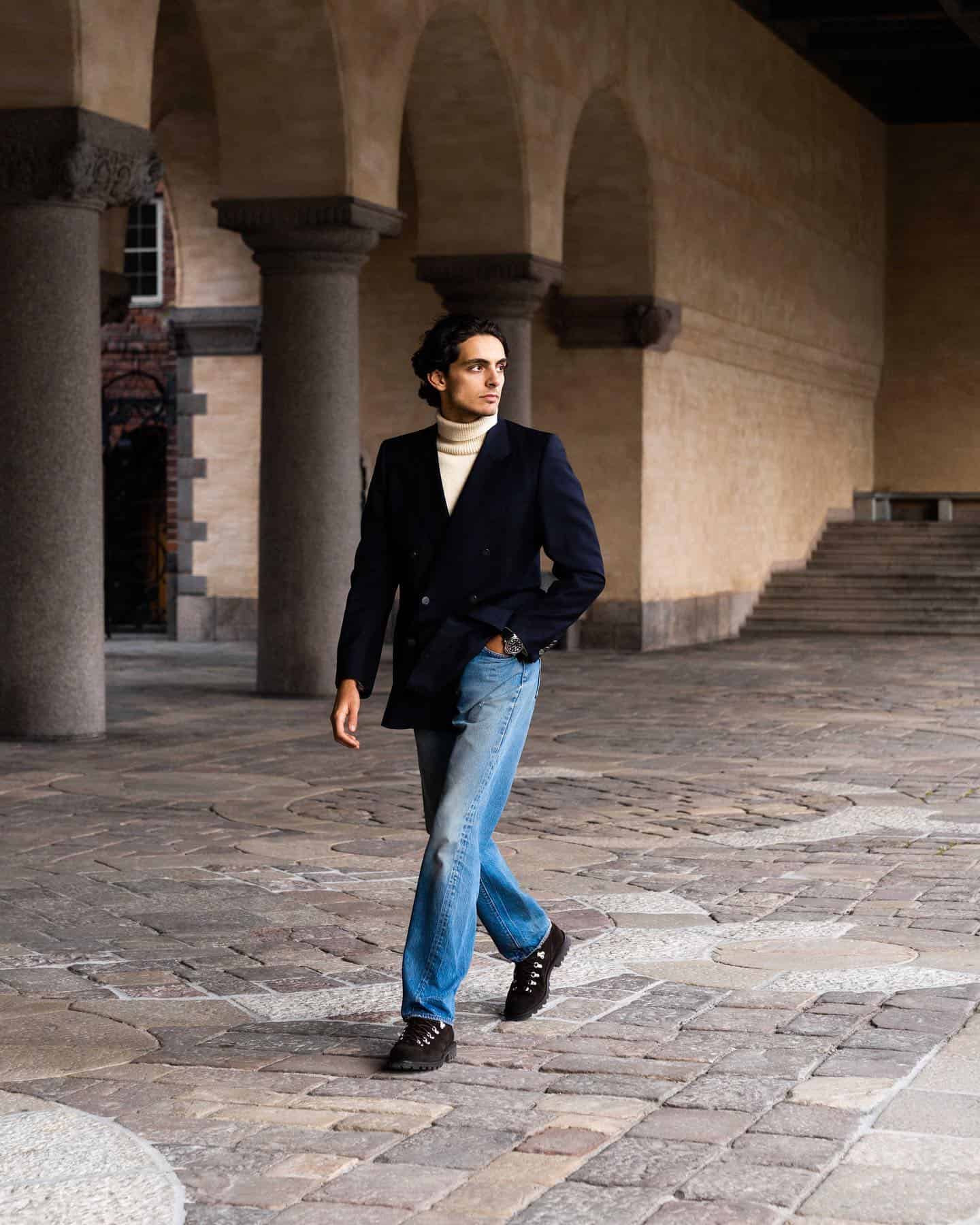 man in a double breasted blazer looking back while walking