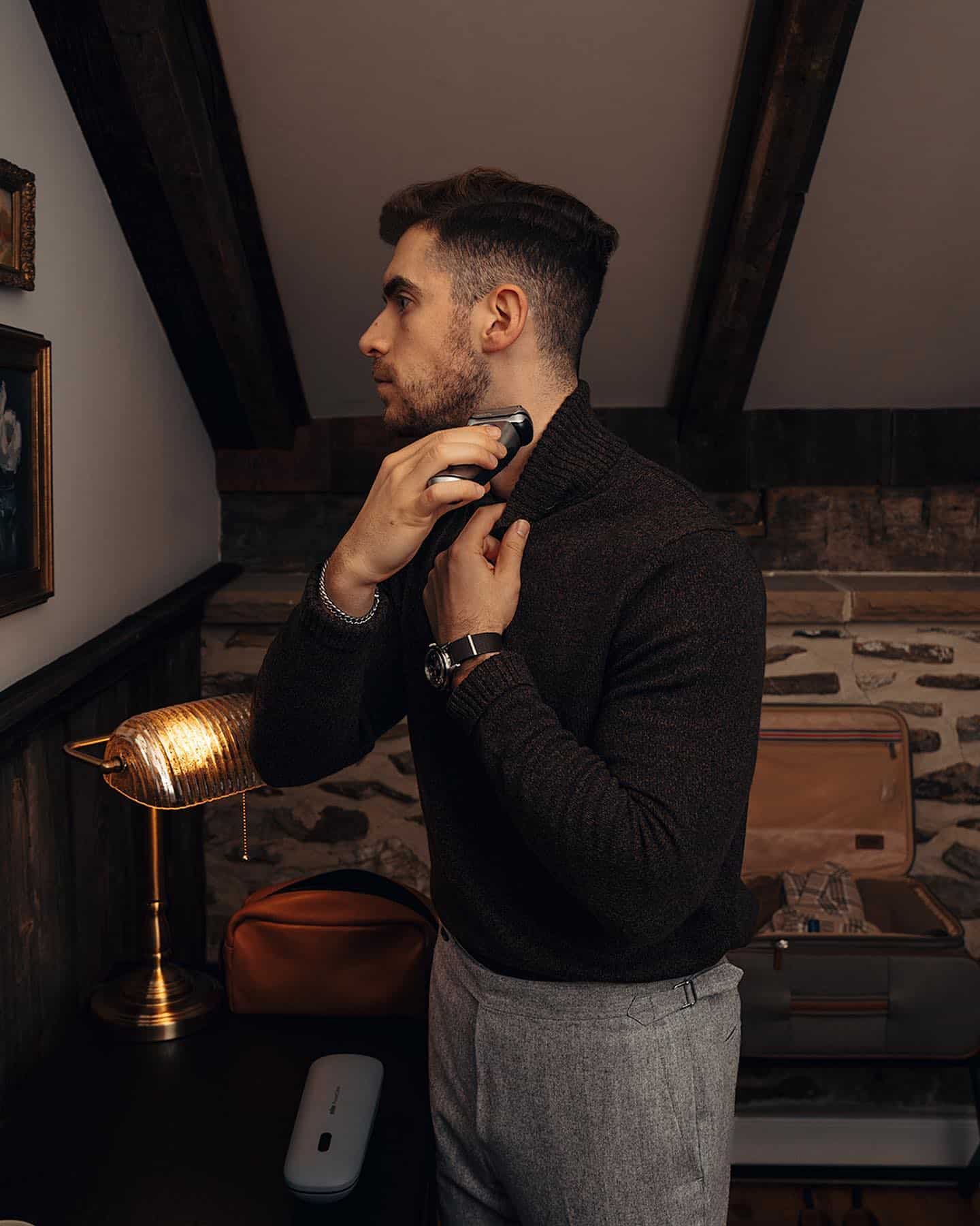 man shaving his beard by the neck