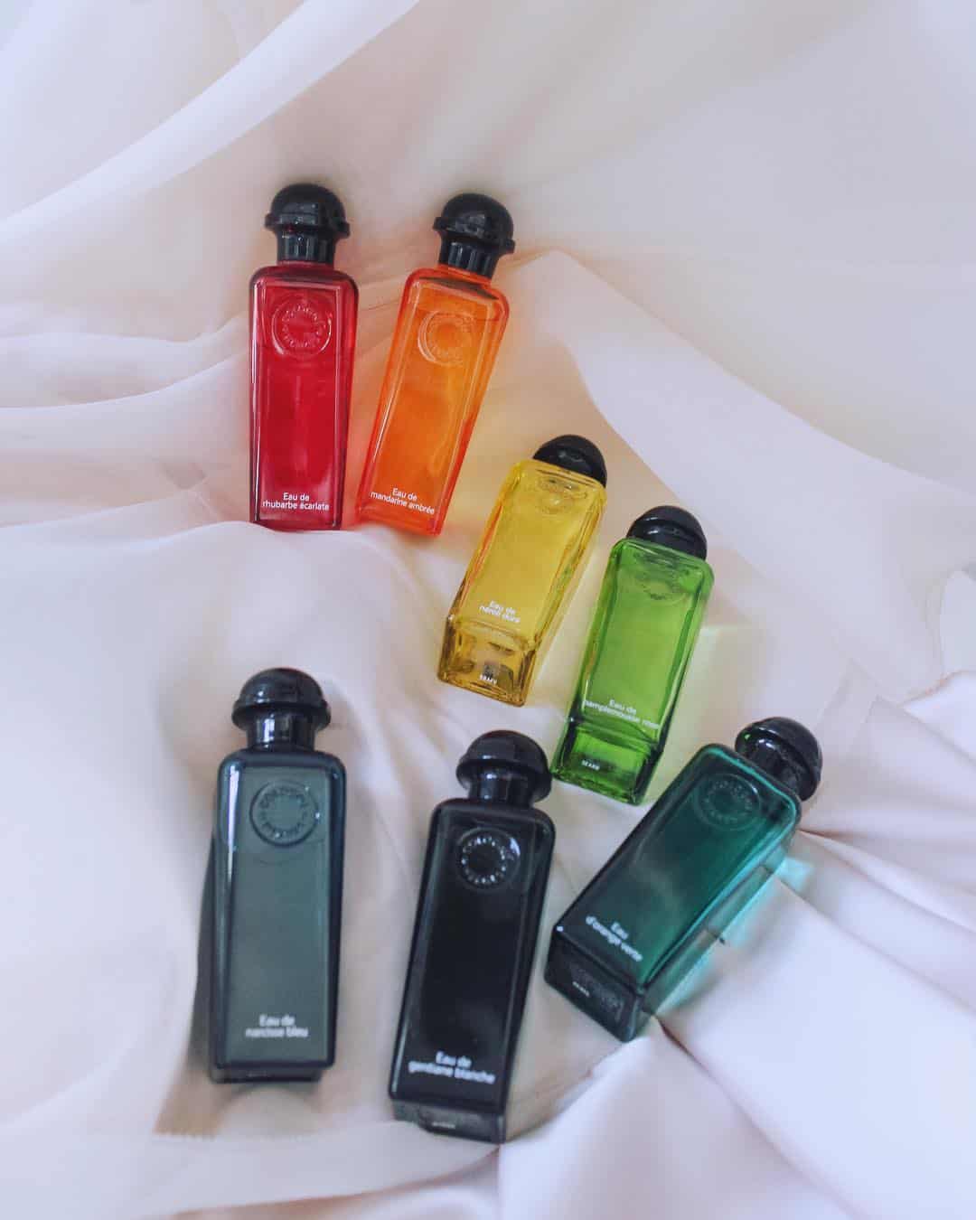 a collection of colorful hermes colognes