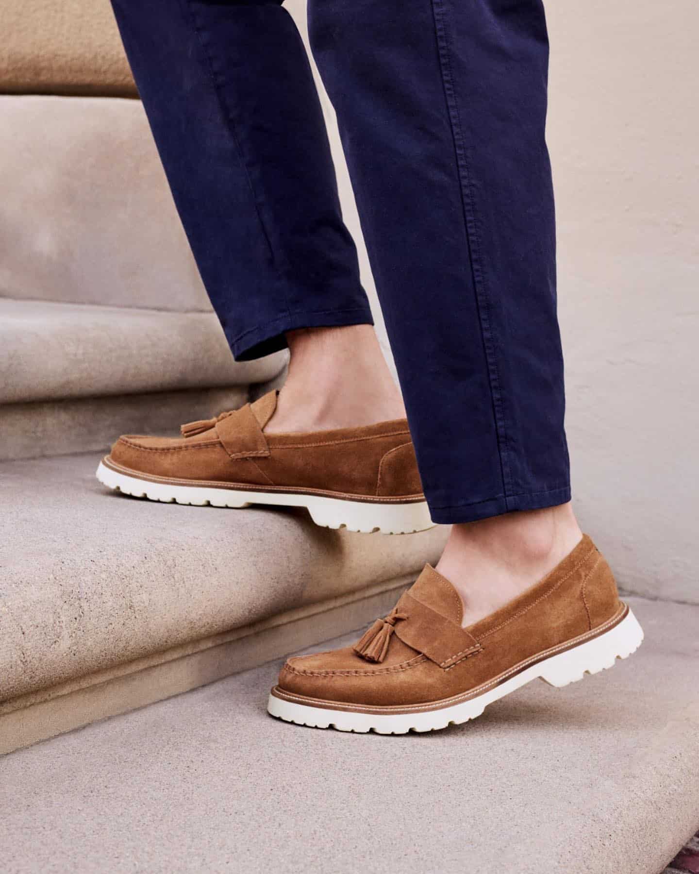 going up the stairs with a pair of loafers