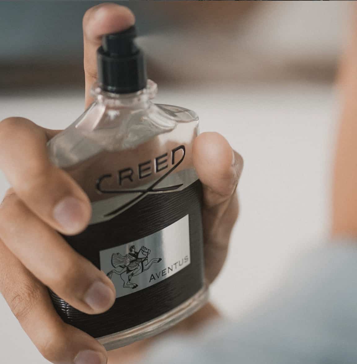 Bottle of Creed Adventus being sprayed 