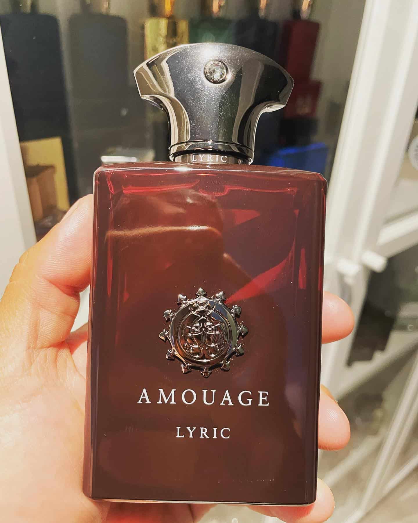 holding a bottle of amouage lyric man