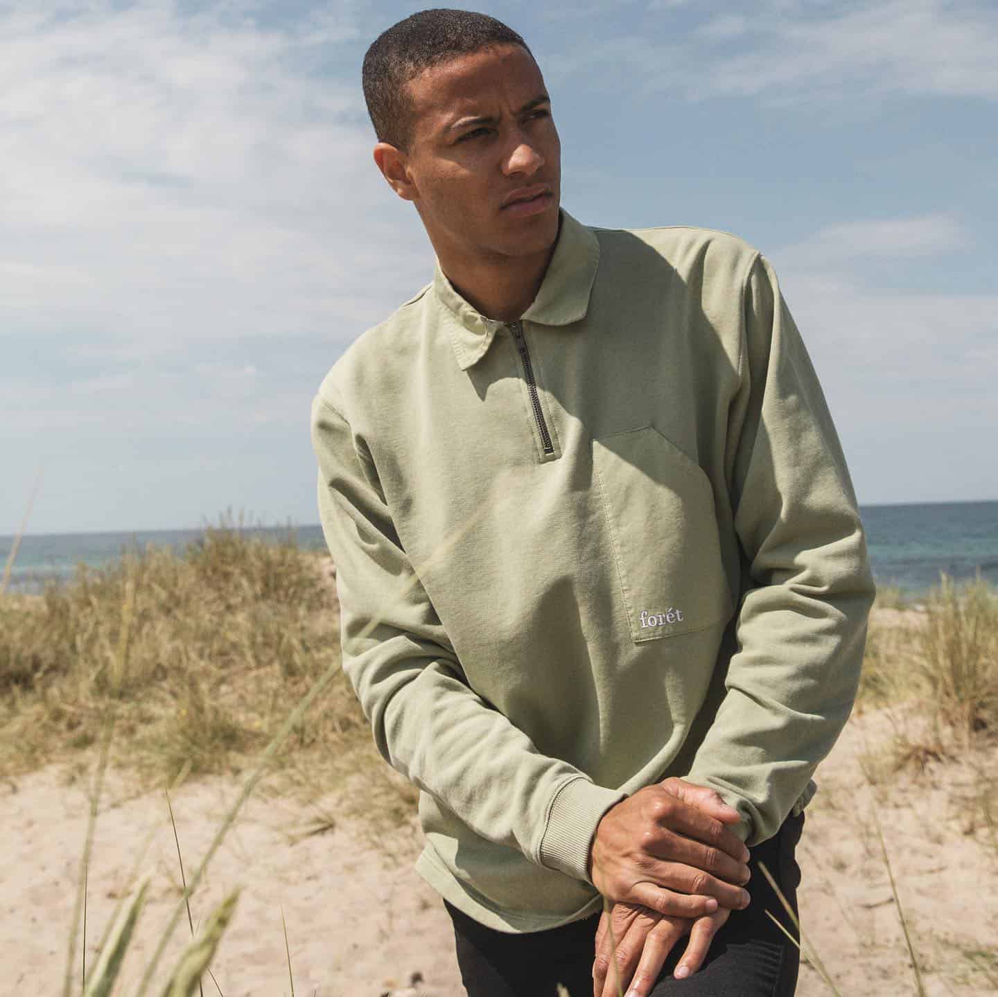 man wearing a half zip foret sweatshirt