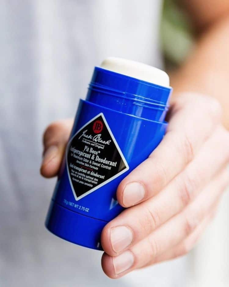 holding a pit boss deodorant by jack black