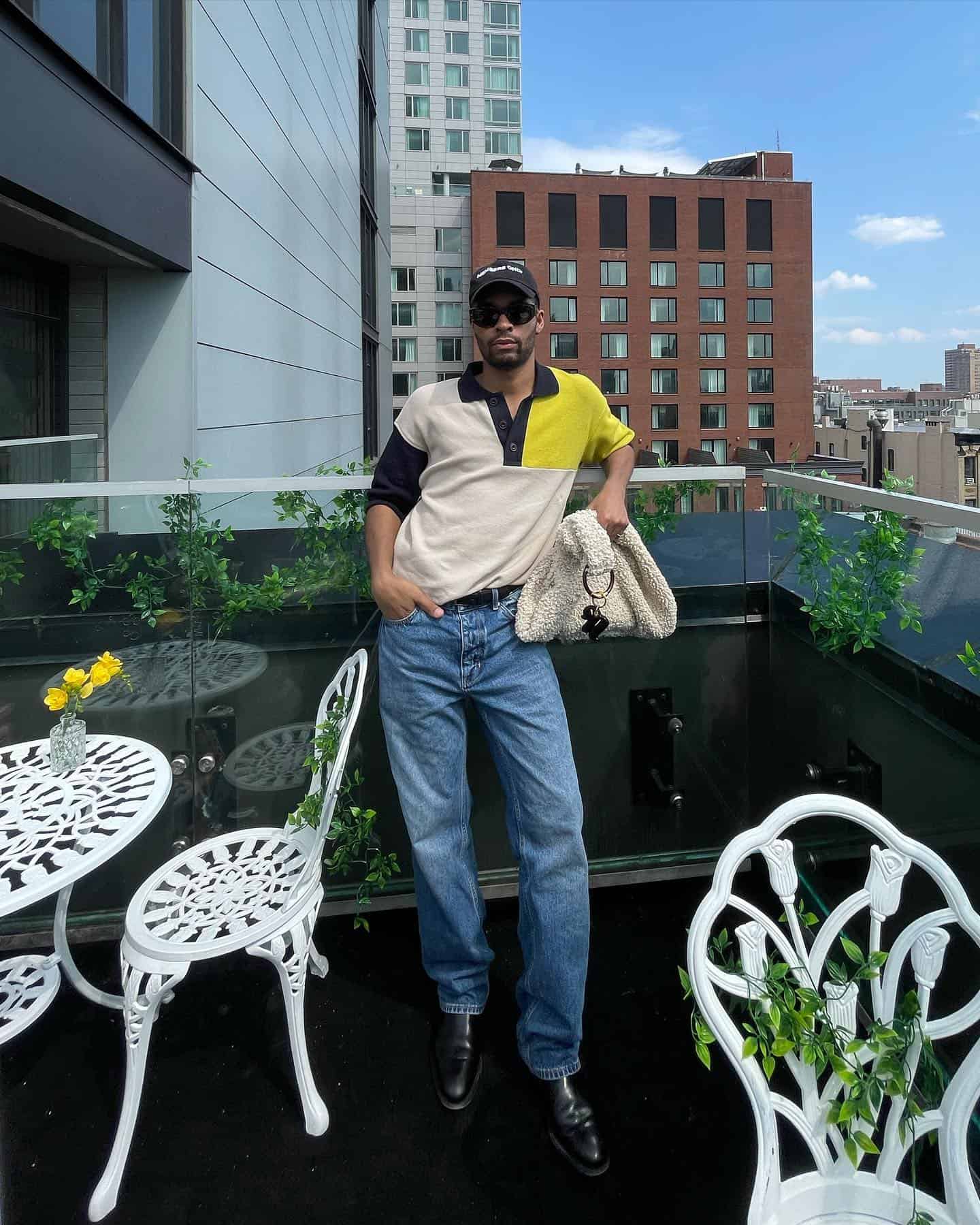 man leaning his back on a balcony