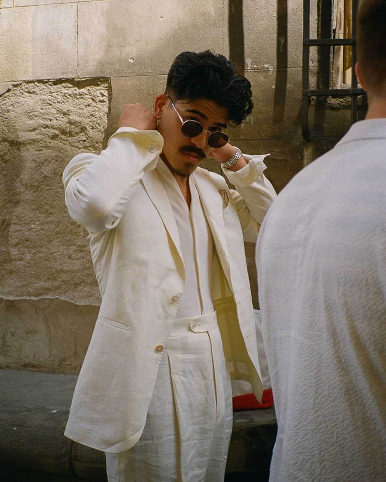 man fixing the colar of his linen suit jacket