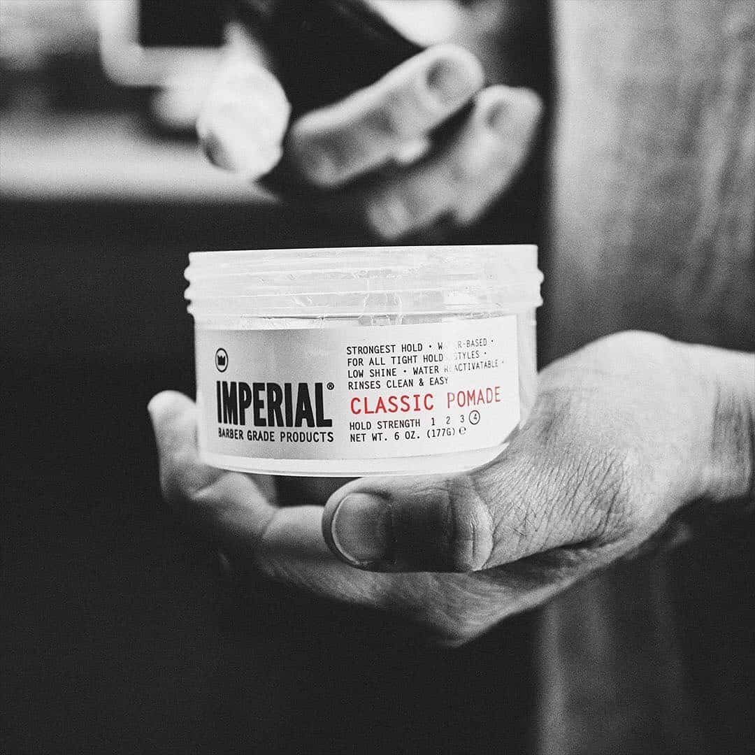 holding a classic pomade from Imperial barber
