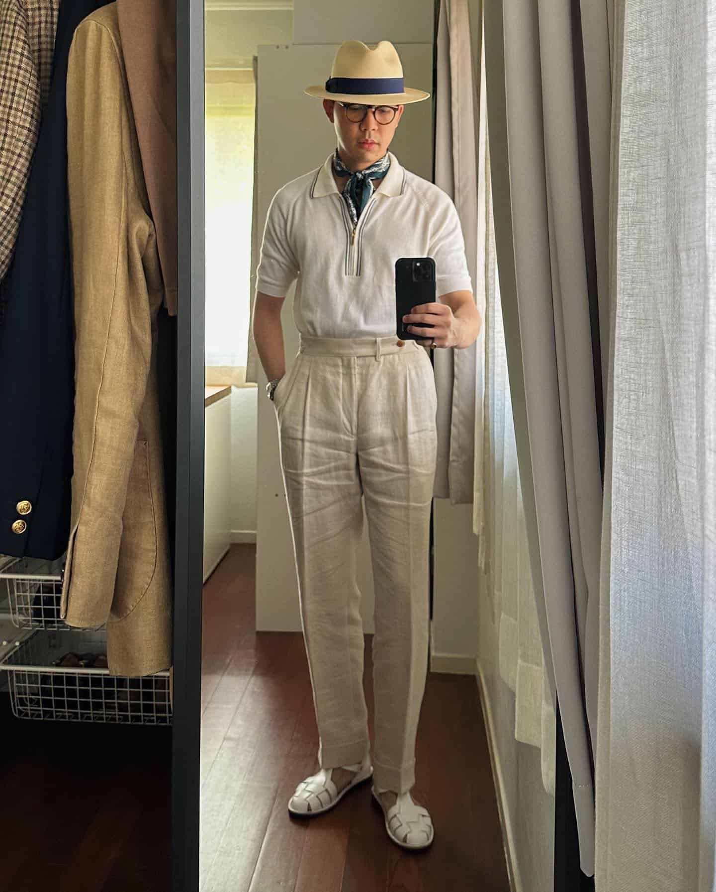 man taking a mirror selfie with a straw hat on
