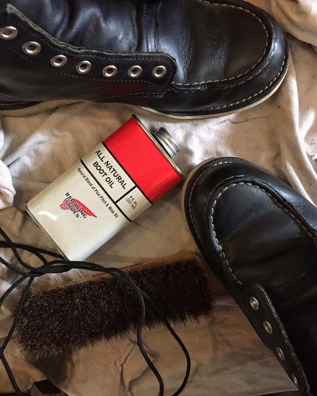 cleaning a pair of boots with redwing's boot oil and a shoe brush